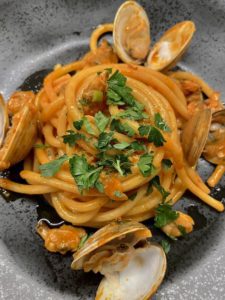 Pasta with steamed clams topped with parsley