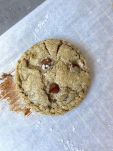 Cookie on parchment paper with a trace of melted chocolate