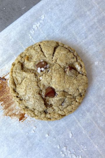 Cookie on parchment paper with a trace of melted chocolate