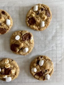 Wire rack showing irregular shaped chocolate chip s'mores cookies