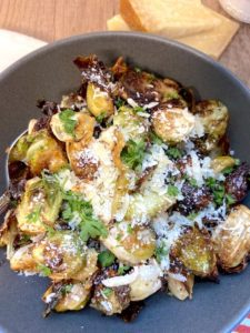 Close up of roasted brussel sprouts garnished with parmigiano reggiano 
