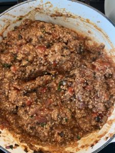 Cooked quinoa evenly mixed into the tomato and ground beef stuffing mixture.