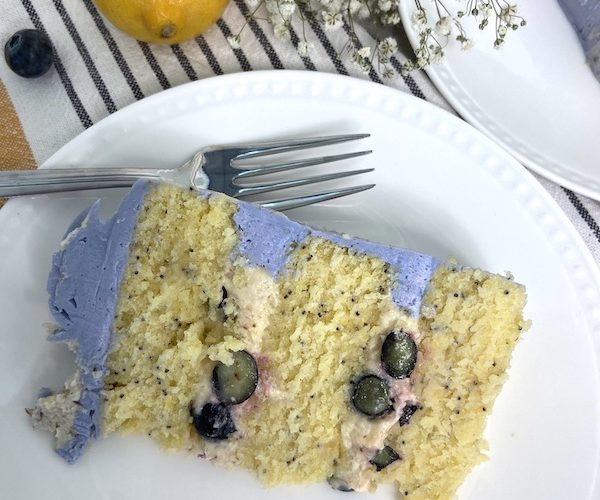 Lemon poppy seed cake - slice of cake showing the lemon lavender cream cheese filling and Italian buttercream