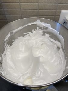After the sugar syrup, firm peaks form into the meringue and that's how we know the meringue is ready and done.