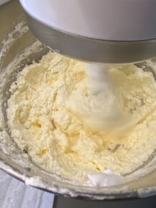 Making Italian buttercream - Adding dollops of butter into the meringue to make italian buttercream. Halfway through, the consistency is "soupy" but it's normal.