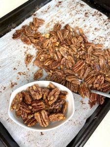3-Ingredient roasted maple pecans - Pecan bowl on baking tray with spoon