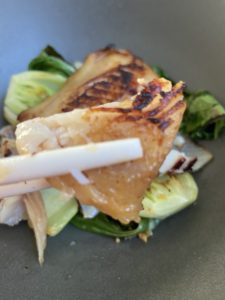 Bite of miso black cod with chopsticks