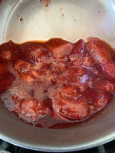 Cooked strawberries in saucepan