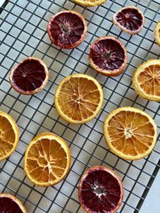 Cooling wire rack with dehydrated slices of orange and blood orange