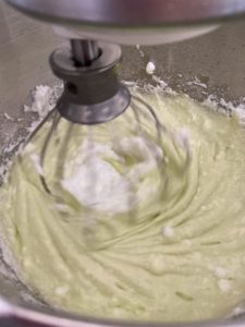 Making the chiffon cake by mixing the meringue into the batter
