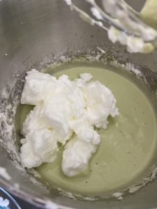 mixing the meringue into the batter.