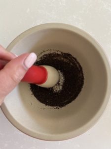 Grinding Earl Grey tea leaves with a mortar and pestle