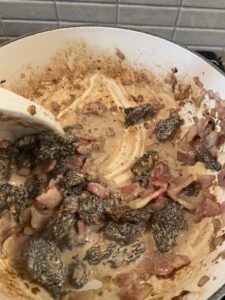 Adding heavy cream to the morels and pancetta mixture. Deglazing the pan.