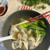 Image showing a bowl of cooked wontons eaten with broth and bok choy