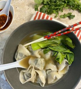 Image showing a bowl of cooked wontons eaten with broth and bok choy