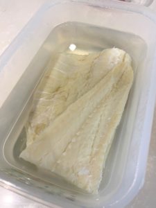 Soaking salted cod overnight.