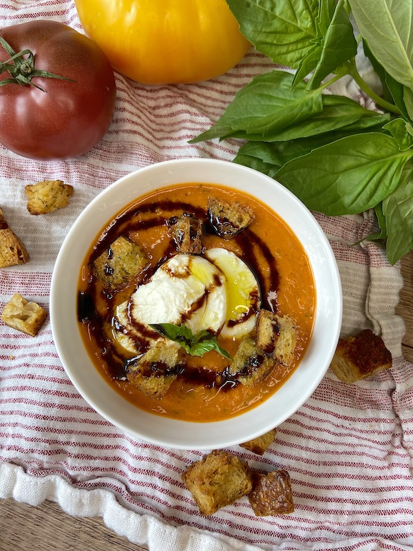 Presentation of Roasted Caprese Bocconcini soup with balsamic glaze, olive oil and croutons