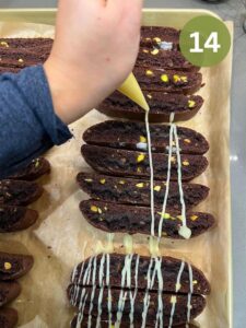 Pipping biscotti with melted chocolate