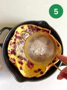 Dusting pancake with powdered sugar