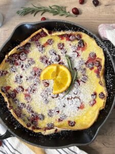 Close up picture of Cranberry Orange Dutch Baby pancake.