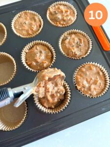 dividing muffin batter into muffin liners to make morning power bran muffins.
