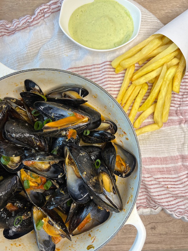 Mussels in a Dutch Oven with a side of fries.