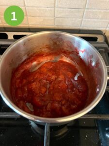 Making strawberry puree in saucepan,