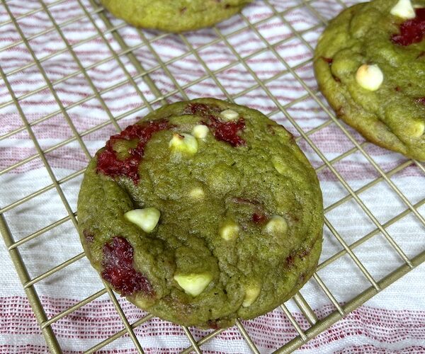 Close up of one Strawberry chocolate chip matcha cookies on wire rack